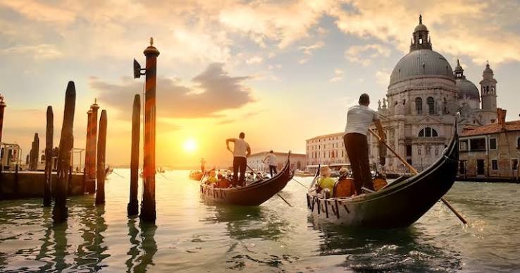 Venice gondola through back canals at sunset